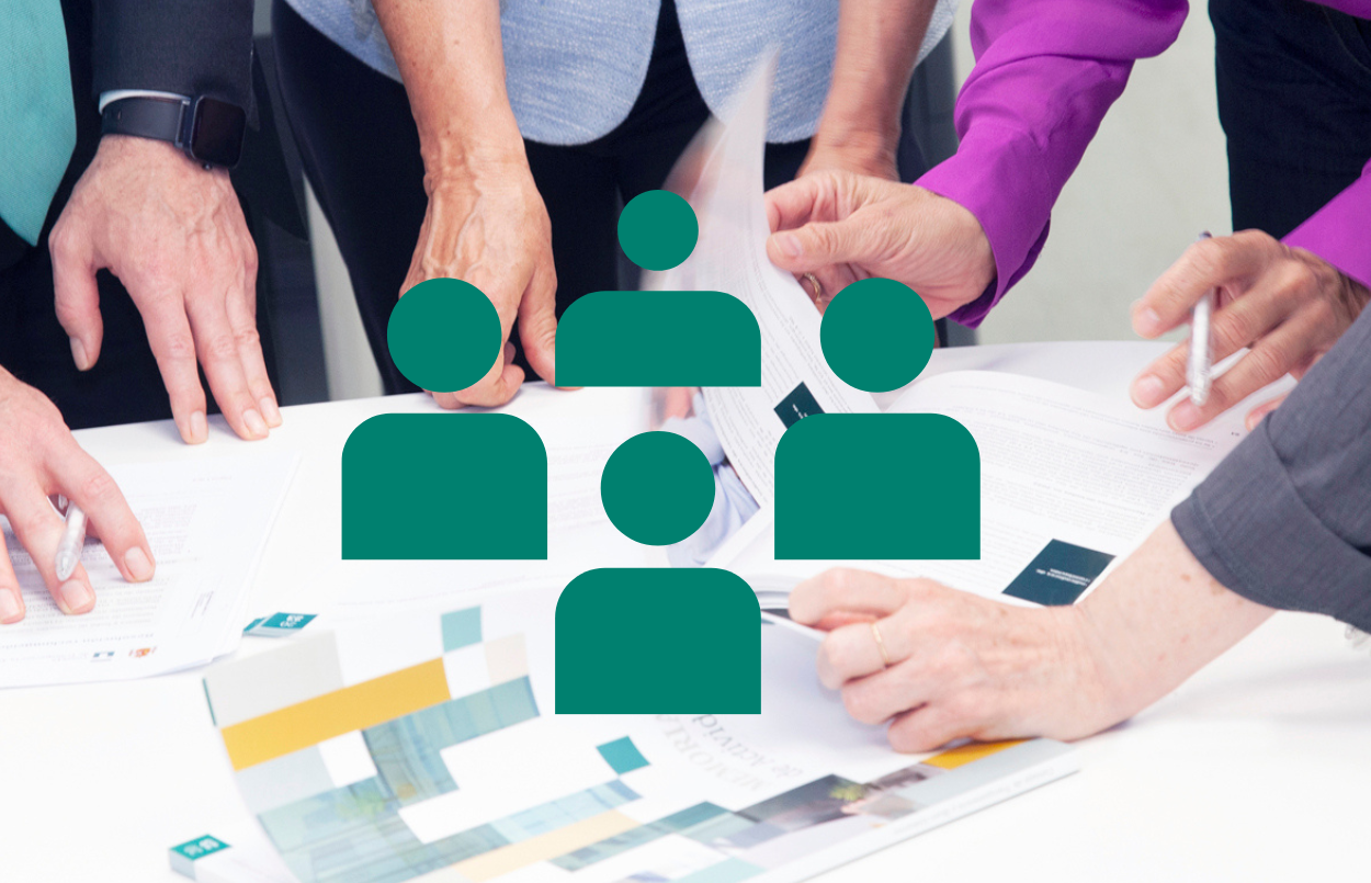 Personas mirant un informe amb icona de responsables