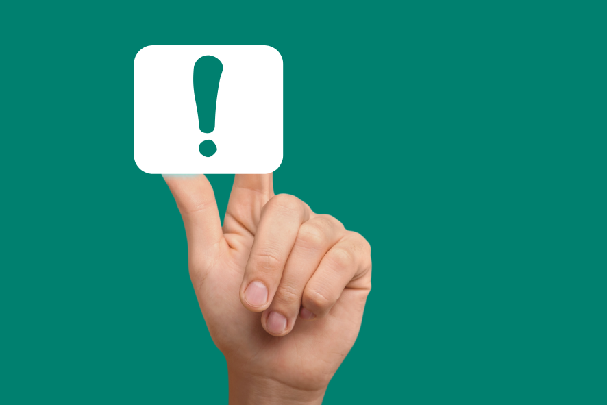 a hand touching an exclamation mark